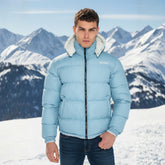 Model wearing Glacier Blue UKRA Puffer Jacket in snow mountains.